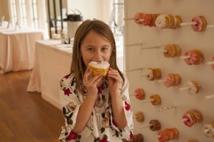 Girl eating a donut at the Be-you-ti-ful Birmingham Fashion Show